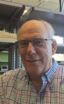 Bioengineering lab manager Randy Warren wears glasses and a light, collared shirt in his lab