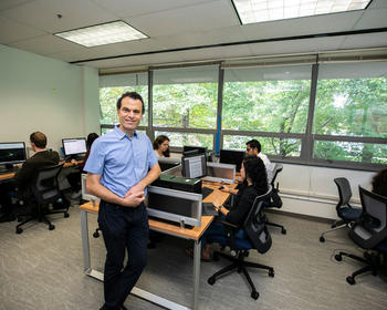 Giorgio Ascoli standing in a computer classroom full of students.