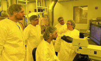 A professor addresses students in a lab setting