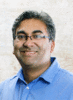 Mason bioengineering associate professor Parag Chitnis wears a blue-collared shirt and glasses with salt/pepper hair in his faculty profile